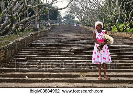 "Girl with lotus flowers on the stone stairs to the Buddhist temple complex of Mihintale, Anuradhapura, North Central Province, Sri Lanka, Asia" View Large Photo Image Stock Image - "Girl with lotus flowers on the stone stairs to the Buddhist temple complex of Mihintale, Anuradhapura, North Central Province, Sri Lanka, Asia". Fotosearch