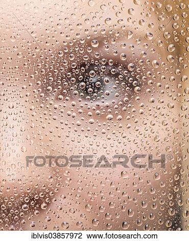 Girl's face through glass pane covered with raindrops View Large Photo Image Stock Image - Girl's face through glass pane covered with raindrops. Fotosearch
