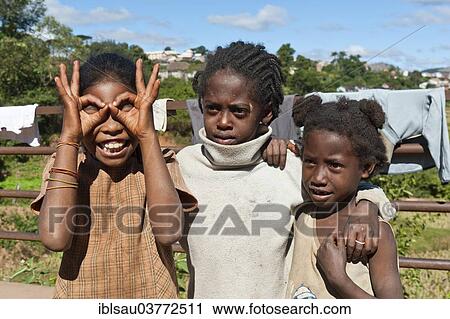 Stock Image - "Girls of the Betsileo people, making faces, Ambositra, Madagascar, Africa". Fotosearch