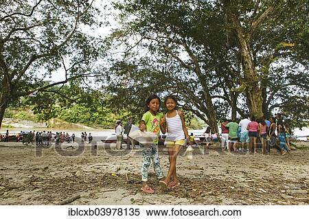 Stock Photography - "Girls selling sugar cane on the jungle beach of Misahualli, Napo Province, Ecuador, South America". Fotosearch