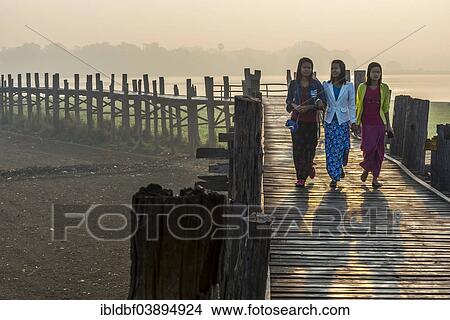 "Girls with tanaka on their faces on a teak bridge, U Bein Bridge over Taungthaman Lake, in the morning light, Amarapura, Mandalay Division, Myanmar, Asia" View Large Photo Image Picture - "Girls with tanaka on their faces on a teak bridge, U Bein Bridge over Taungthaman Lake, in the morning light, Amarapura, Mandalay Division, Myanmar, Asia". Fotosearch