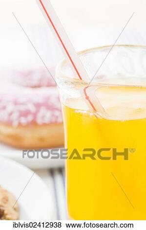 Glass of orange soda with drinking straw View Large Photo Image Stock Photo - Glass of orange soda with drinking straw. Fotosearch