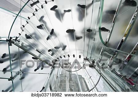 "Glass spiral staircase with people and skyscrapers from below, Manhattan, New York City, New York, United States, North America" View Large Photo Image Stock Image - "Glass spiral staircase with people and skyscrapers from below, Manhattan, New York City, New York, United States, North America". Fotosearch