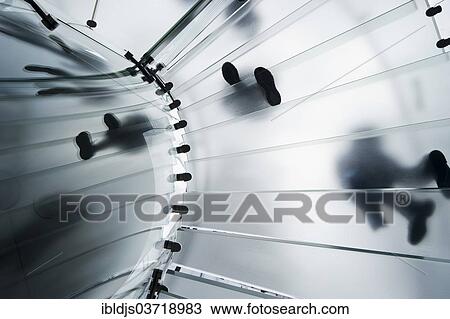 Stock Image - "Glass spiral staircase with people from below, Manhattan, New York City, New York, United States, North America". Fotosearch