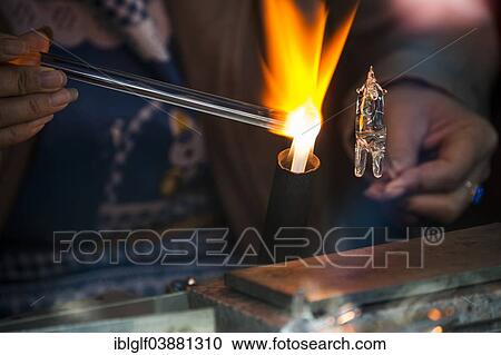 "Glassblower working on a glass figure with a flame, Wuzhen, Zhejiang province, China, Asia" View Large Photo Image Stock Image - "Glassblower working on a glass figure with a flame, Wuzhen, Zhejiang province, China, Asia". Fotosearch