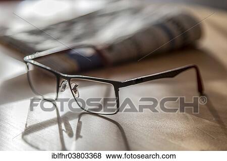 "Glasses lying in front of a daily newspaper, Germany, Europe" View Large Photo Image Stock Photo - "Glasses lying in front of a daily newspaper, Germany, Europe". Fotosearch