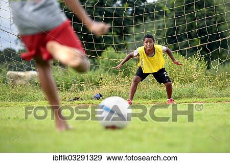 Stock Photo - "Goalkeeper focusing on the ball during a penalty kick, social project in a favela, Poxoreo, Mato Grosso, Brazil, South America". Fotosearch