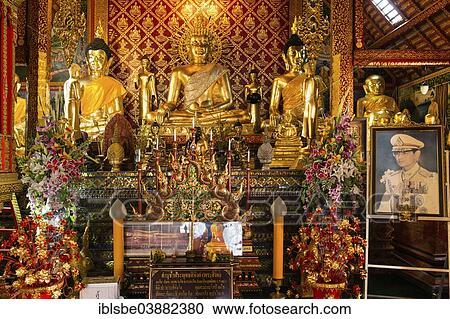 "Golden Buddha statues and a picture of King Bhumibol Adulyadej in Wat Phrah Singh Temple, Chiang Rai, Chiang Rai province, Northern Thailand, Thailand, Asia" View Large Photo Image Stock Image - "Golden Buddha statues and a picture of King Bhumibol Adulyadej in Wat Phrah Singh Temple, Chiang Rai, Chiang Rai province, Northern Thailand, Thailand, Asia". Fotosearch