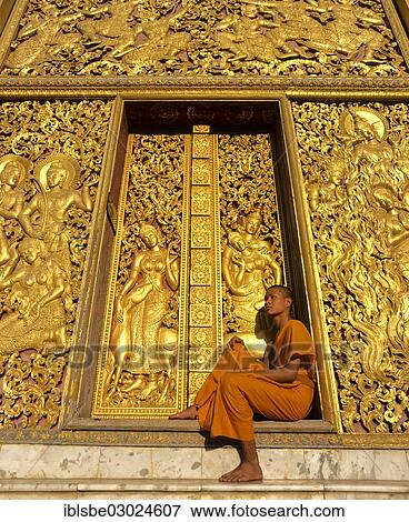 "Golden reliefs, monk at the entrance to the Carriage House, Wat Xieng Tong or Vat Xienthong, Luang Prabang, Luang Prabang Province, Laos, Asia" View Large Photo Image Stock Photo - "Golden reliefs, monk at the entrance to the Carriage House, Wat Xieng Tong or Vat Xienthong, Luang Prabang, Luang Prabang Province, Laos, Asia". Fotosearch