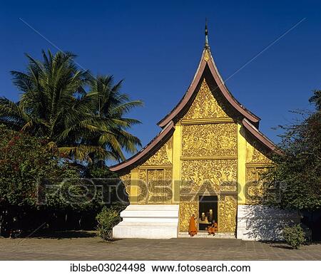 Stock Photo - "Golden reliefs, monks at the entrance to the Carriage House, Wat Xieng Tong or Vat Xienthong, Luang Prabang, Luang Prabang Province, Laos, Asia". Fotosearch