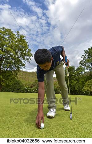 "Golfer reaching for a ball, Hua Hin, Thailand, Asia" View Large Photo Image Stock Photograph - "Golfer reaching for a ball, Hua Hin, Thailand, Asia". Fotosearch
