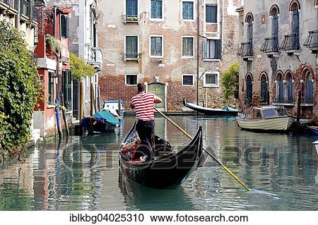 Stock Image - "Gondola with gondolier using cell phone, Dorsoduro, Venice, Veneto, Italy, Europe". Fotosearch