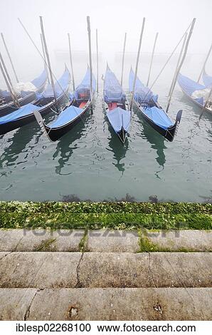 Stock Image - "Gondolas in the fog, Molo della Piazzetta, St. Mark's Square, Piazza San Marco, Venice, Venezia, Veneto, Italy, Europe". Fotosearch
