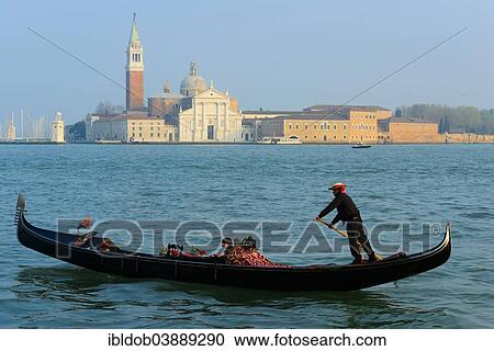 Stock Image - "Gondolier onn the Bacino San Marco, Church of San Giorgio Maggiore at the back, Venice, Veneto, Italy, Europe". Fotosearch