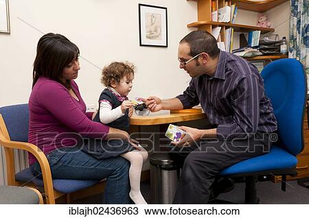 "GP doctor rewarding child patient with stickers during a consultation, United Kingdom, Europe" View Large Photo Image Stock Image - "GP doctor rewarding child patient with stickers during a consultation, United Kingdom, Europe". Fotosearch