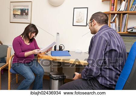 "GP doctor's surgery, patient consultation, pregnant woman reading information, United Kingdom, Europe" View Large Photo Image Picture - "GP doctor's surgery, patient consultation, pregnant woman reading information, United Kingdom, Europe". Fotosearch