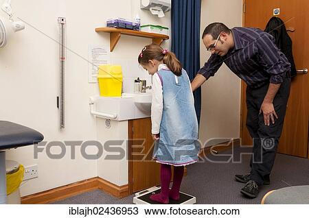 Stock Image - "GP doctor's surgery, patient consultation, child being weighed, United Kingdom, Europe". Fotosearch