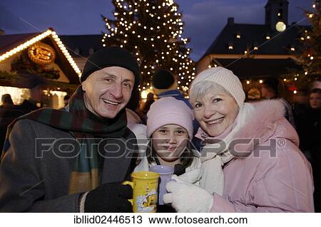 Stock Image - "Granddaughter and Grandparents and at the Christmas market in Annaberg-Buchholz, Saxony, Germany, Europe". Fotosearch