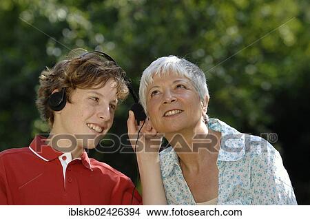 Picture - Grandma and grandson with headphones listening to music together. Fotosearch