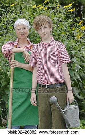 Grandmother and grandson are working together in the garden View Large Photo Image Stock Image - Grandmother and grandson are working together in the garden. Fotosearch