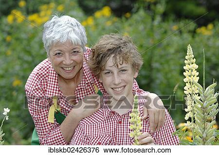 Grandmother and grandson in a garden View Large Photo Image Stock Photograph - Grandmother and grandson in a garden. Fotosearch