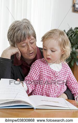 "Grandmother reading from a book to her granddaughter, 3 years" View Large Photo Image Stock Photo - "Grandmother reading from a book to her granddaughter, 3 years". Fotosearch