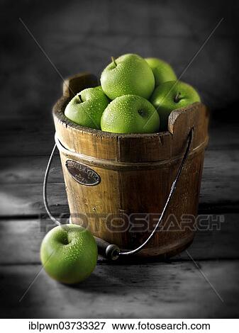 Granny Smith apples in a wooden bucket View Large Photo Image Stock Photo - Granny Smith apples in a wooden bucket. Fotosearch