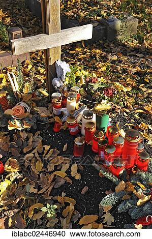 "Grave with votive candles and autumn leaves on the Ostfriedhof or East Cemetery, Munich, Bavaria, Germany, Europe" View Large Photo Image Stock Image - "Grave with votive candles and autumn leaves on the Ostfriedhof or East Cemetery, Munich, Bavaria, Germany, Europe". Fotosearch