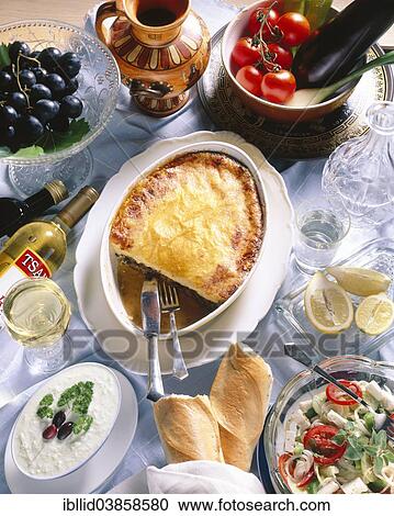 "Greek national cuisine, salad with feta cheese, tzatziki, moussaka, Retsina wine" View Large Photo Image Stock Image - "Greek national cuisine, salad with feta cheese, tzatziki, moussaka, Retsina wine". Fotosearch
