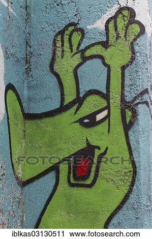 "Green cartoon character holding up its hands, graffiti, Meiderich, Duisburg, Ruhr district, North Rhine-Westphalia, Germany, Europe" View Large Photo Image Stock Image - "Green cartoon character holding up its hands, graffiti, Meiderich, Duisburg, Ruhr district, North Rhine-Westphalia, Germany, Europe". Fotosearch