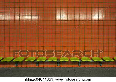 "Green seats in front of an orange tiled wall in an underdground station, Nuremberg, Middle Franconia, Bavaria, Germany, Europe" View Large Photo Image Stock Image - "Green seats in front of an orange tiled wall in an underdground station, Nuremberg, Middle Franconia, Bavaria, Germany, Europe". Fotosearch