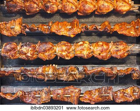 "Grilled chicken spit roasted at a market, United Kingdom, Europe" View Large Photo Image Stock Image - "Grilled chicken spit roasted at a market, United Kingdom, Europe". Fotosearch