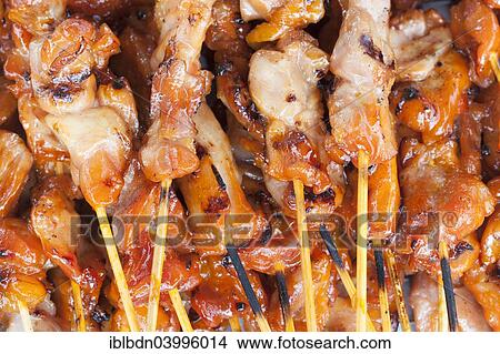 Picture - "Grilled meat skewers on sale at a market, Thailand, Asia". Fotosearch