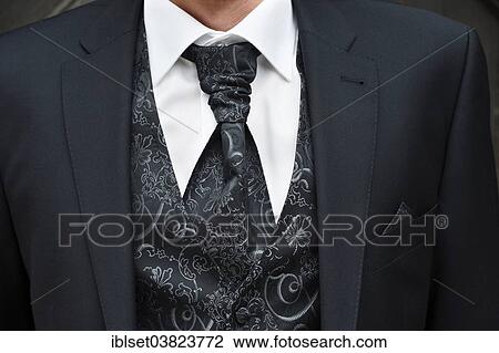 Stock Image - "Groom wearing a suit, a tie and a waistcoast". Fotosearch