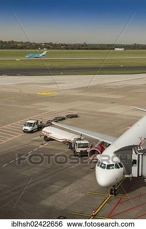 Ground refuelling of an aircraft with a tanker, Duesseldorf International Airport, North Rhine-Westphalia, Germany, Europe View Large Photo Image Stock Photograph - Ground refuelling of an aircraft with a tanker, Duesseldorf International Airport, North Rhine-Westphalia, Germany, Europe. Fotosearch