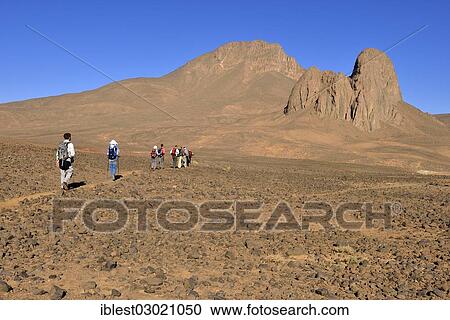 Stock Image - "Group of hikers at the diatreme, volcanic pipe of Tahat mountain, Hoggar Mountains, Atakor, Tamanrasset Province, Algeria, Africa". Fotosearch