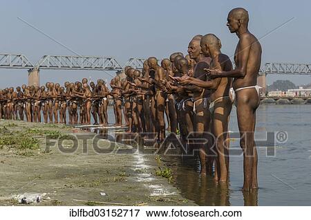 "Group of men standing in the river Ganges, as part of the initiation of new sadhus, during Kumbha Mela festival, Allahabad, Uttar Pradesh, India, Asia" View Large Photo Image Stock Photo - "Group of men standing in the river Ganges, as part of the initiation of new sadhus, during Kumbha Mela festival, Allahabad, Uttar Pradesh, India, Asia". Fotosearch