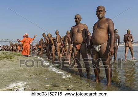 Stock Photography - "Group of men standing in the river Ganges, getting orders by gurus as part of the initiation of new sadhus, during Kumbha Mela festival, Allahabad, Uttar Pradesh, India, Asia". Fotosearch