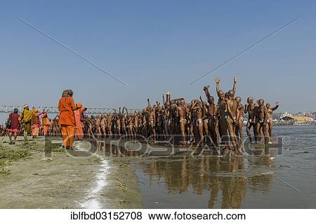 Stock Photo - "Group of new sadhus standing in the river Ganges, getting orders from gurus as part of their initiation, during Kumbha Mela festival, Allahabad, Uttar Pradesh, India, Asia". Fotosearch