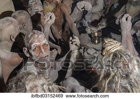 "Group of newly initiated Shiva sadhus from Avahan Akhara, holy men, sitting around a bonfire, during Kumbha Mela festival, Allahabad, Uttar Pradesh, India, Asia" View Large Photo Image Stock Photo - "Group of newly initiated Shiva sadhus from Avahan Akhara, holy men, sitting around a bonfire, during Kumbha Mela festival, Allahabad, Uttar Pradesh, India, Asia". Fotosearch