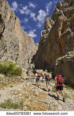 Stock Image - "Group of people hiking in Cimbar Canyon, Aladaglar National Park, High or Anti-Taurus Mountains, Turkey, Asia". Fotosearch