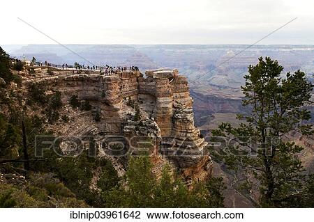 "Group of tourists enjoy the view from the South Rim of Grand Canyon, Arizona, USA" View Large Photo Image Stock Image - "Group of tourists enjoy the view from the South Rim of Grand Canyon, Arizona, USA". Fotosearch