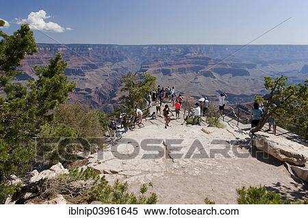 "Group of tourists enjoy the view from the South Rim of Grand Canyon, Arizona, USA" View Large Photo Image Stock Photography - "Group of tourists enjoy the view from the South Rim of Grand Canyon, Arizona, USA". Fotosearch