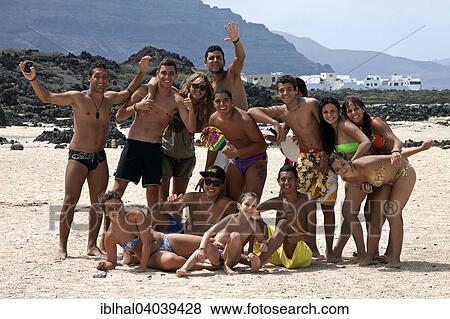 "Group of young people on the beach, Bajo de los Sables in Orzola, Lanzarote, Canary Islands, Spain, Europe" View Large Photo Image Stock Photo - "Group of young people on the beach, Bajo de los Sables in Orzola, Lanzarote, Canary Islands, Spain, Europe". Fotosearch