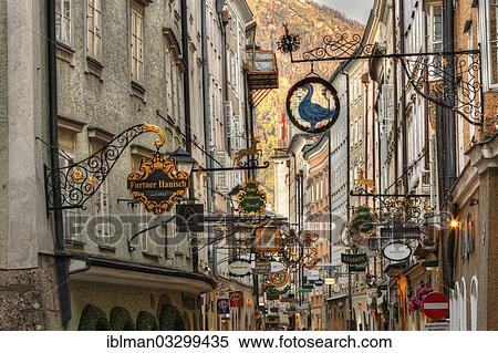 Stock Photography - "Guild signs, """"Getreidegasse"""" alley, evening light, historic center, Salzburg, Salzburg State, Austria, Europe". Fotosearch