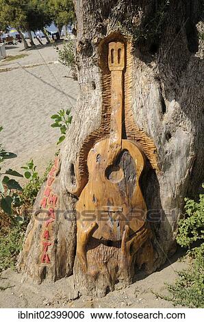 "Guitar carved in a tree by hippies, Matala, Crete, Greece, Europe" View Large Photo Image Stock Photograph - "Guitar carved in a tree by hippies, Matala, Crete, Greece, Europe". Fotosearch