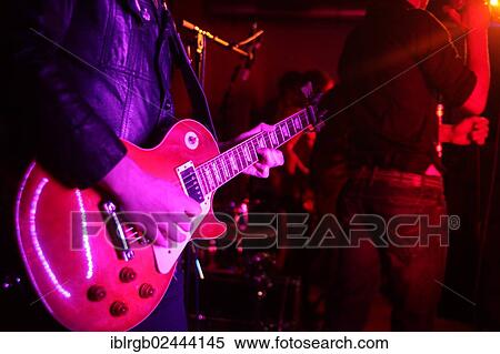 Guitar player performing at a concert View Large Photo Image Stock Photography - Guitar player performing at a concert. Fotosearch