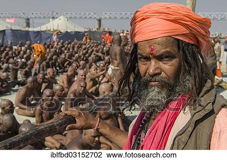 Stock Image - "Guru guiding the initiation of new sadhus, during Kumbha Mela festival, Allahabad, Uttar Pradesh, India, Asia". Fotosearch