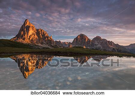 Picture - "Gusela mountain at sunrise reflected in small lake, Giau Pass, Dolomites, Veneto, Italy, Europe". Fotosearch