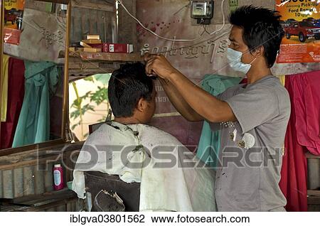 "Hairdresser cutting a customer's hair at a hair salon, Areyskat, Phnom Penh, Cambodia, Asia" View Large Photo Image Stock Image - "Hairdresser cutting a customer's hair at a hair salon, Areyskat, Phnom Penh, Cambodia, Asia". Fotosearch